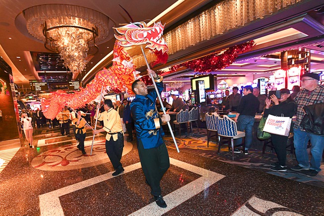 A dragon is paraded throug the Cosmopolitan to help celebrate ...