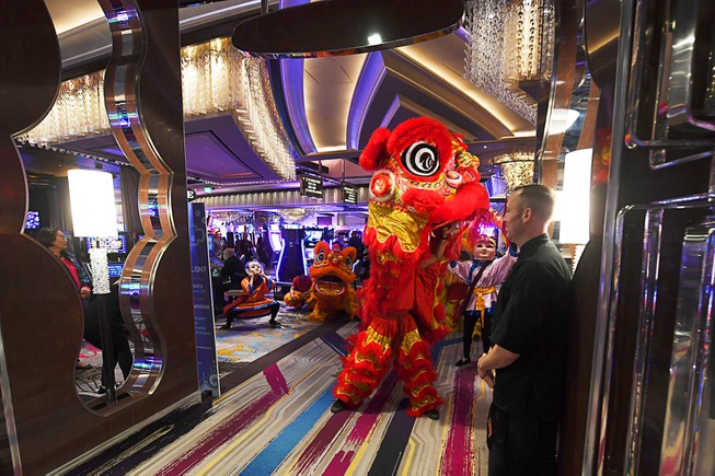 A lion dance makes its way through the casino at ...