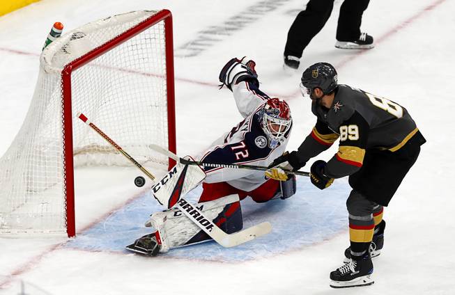 Columbus Blue Jackets goaltender Sergei Bobrovsky (72) deflects a shot by Vegas Golden Knights right wing Alex Tuch (89) during the first period at T-Mobile Arena Saturday, Feb. 9, 2018.