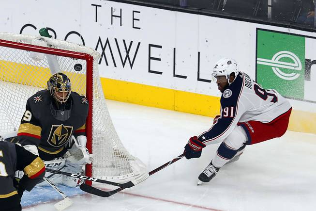 A shot by Columbus Blue Jackets left wing Anthony Duclair (91) passes in front of the net over Vegas Golden Knights goaltender Marc-Andre Fleury (29) during the first period at T-Mobile Arena Saturday, Feb. 9, 2018.