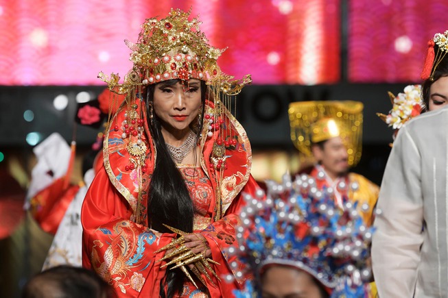 A woman models traditional Asian dress during the Chinese New ...