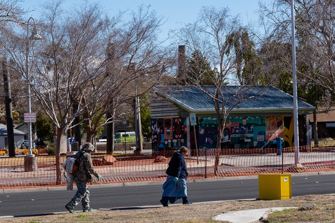 Homeless people pass by the Huntridge Circle Park, Wednesday, Feb. ...