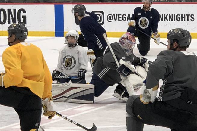 Make-A-Wish recipients Jace Owen, left, and Jay Procter, right, lead a stretch during Golden Knights practice at City National Arena on Feb. 15, 2019.
