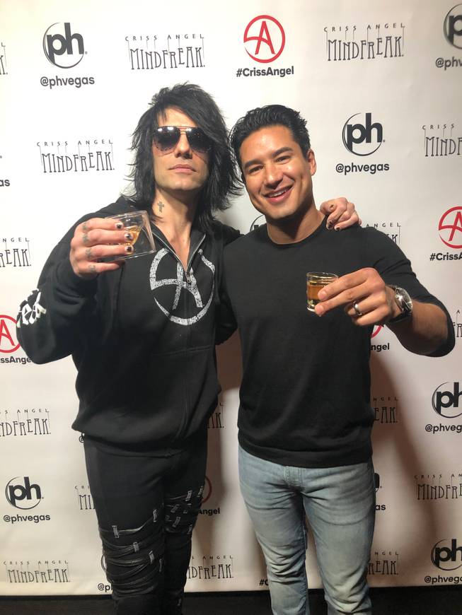 Criss Angel and Mario Lopez toast at Planet Hollywood.