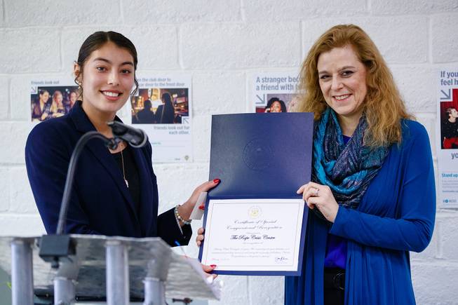 A representative for Rep. Jacky Rosen (D-NV 3rd District) gives a Certificate of Special Congressional Recognition to Director Daniele Staple, right, during a ribbon cutting ceremony for the new Rape Crisis Center Tuesday, Feb. 19, 2019. WADE VANDERVORT