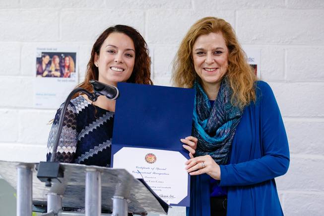A representative for Rep. Susie Lee (D-NV 3rd District) gives a Certificate of Special Congressional Recognition to Director Daniele Staple, right, during a ribbon cutting ceremony for the new Rape Crisis Center Tuesday, Feb. 19, 2019. WADE VANDERVORT