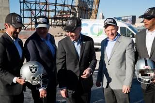 From left, Mark Shearer; SVP for Oakland Raiders, Michael Bolognini; Market VP for Cox Communications Las Vegas, Patrick Esser; president of Cox Communications, Oakland Raiders president Marc Badain and Derrick Hill; vice president Cox Business, pose for a photo in front of the new Raiders Stadium currently under construction, Thurs. Feb. 28, 2019.