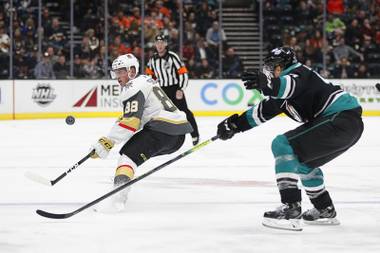 Vegas Golden Knights’ Nate Schmidt, left, controls the puck under pressure from Anaheim Ducks’ Hampus Lindholm during the third period of an NHL hockey game Friday, March 1, 2019, in Anaheim, Calif. The Golden Knights won 3-0.