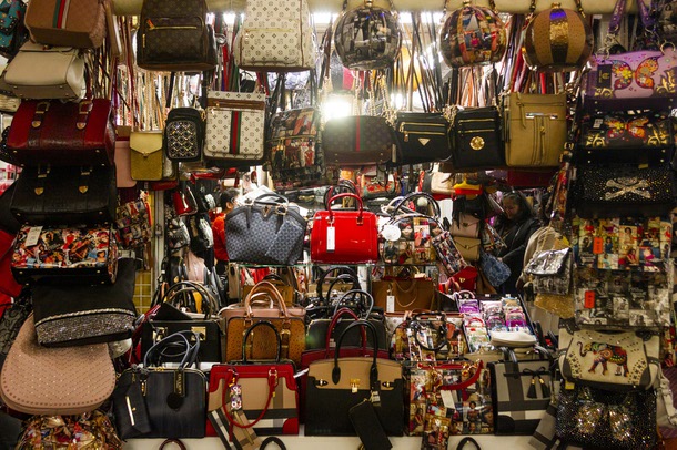 Shoppers look through an array of purses at Fantastic Indoor Swap Meet Sunday, Feb. 17, 2019.