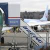 In this photo taken Monday, March 11, 2019, a Boeing 737 MAX 8 airplane being built for TUI Group sits parked in the background at right at Boeing Co.'s Renton Assembly Plant in Renton, Wash.