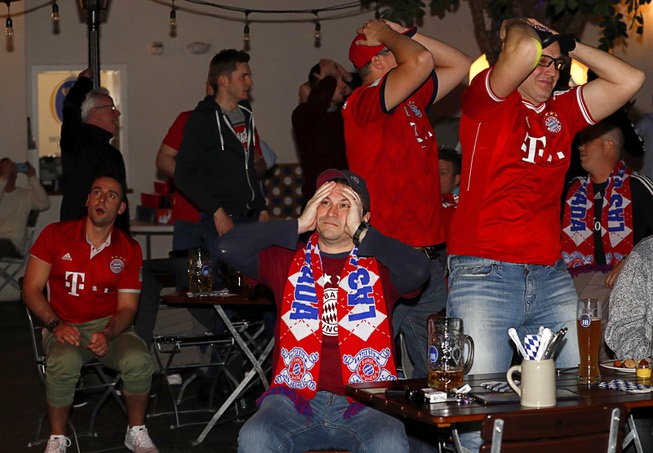 Bayern Munich fans, including Johannes Rothbauer, center, react during a ...