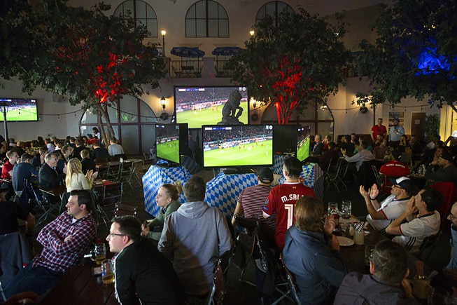 Soccer fans watch a game between FC Liverpool and Bayern ...
