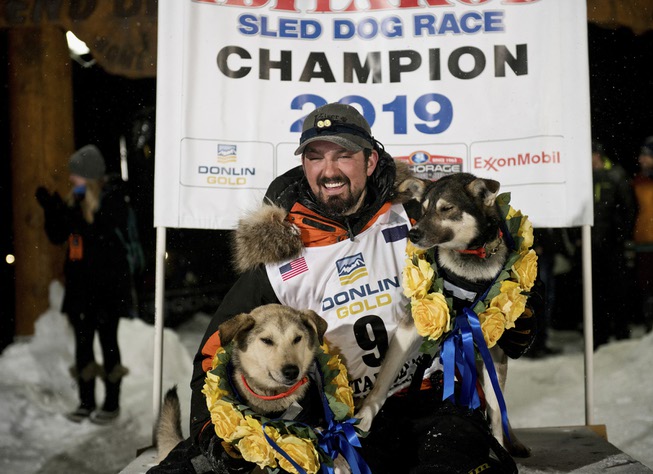 Peter Kaiser (9) poses with his lead dogs, Morrow, left, ...