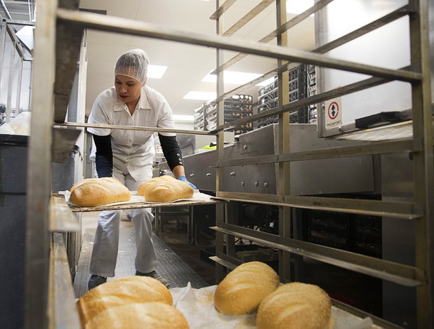 Emerita Zuniga Garcia takes a tray of heavy Italian bread to a packaging line at Great Buns Bakery, 3270 E. Tropicana Ave., Thursday, March 14, 2019. The family-owned bakery has been operating in Las Vegas since 1982.