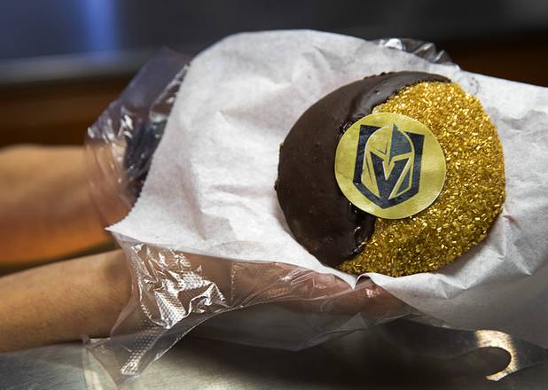 Deborah Morelli displays a Vegas Golden Knights black and white cookie at Great Buns Bakery, 3270 E. Tropicana Ave., Thursday, March 14, 2019. The family-owned bakery has been operating in Las Vegas since 1982.
