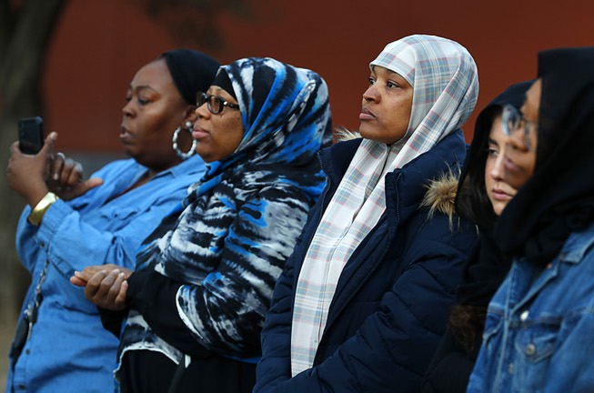 Women listen to speakers during a vigil at UNLV Friday, ...