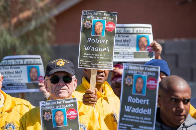 Metro Volunteers hold signs asking the public for any information regarding the slaying of Robert Waddell back in July of 2010, Thursday March 14, 2019.