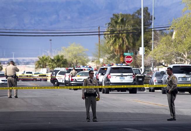 Metro Police officers block off the area after an officer-involved shooting on 9th Street near Bonanza Road Tuesday, March 19, 2019, in Las Vegas. 