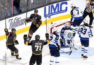 Jonathan Marchessault (81), Reilly Smith (19) and William Karlsson (71) celebrate a goal by Karlsson in the first period against the Winnipeg Jets at T-Mobile Arena Thursday, March 21, 2019.
