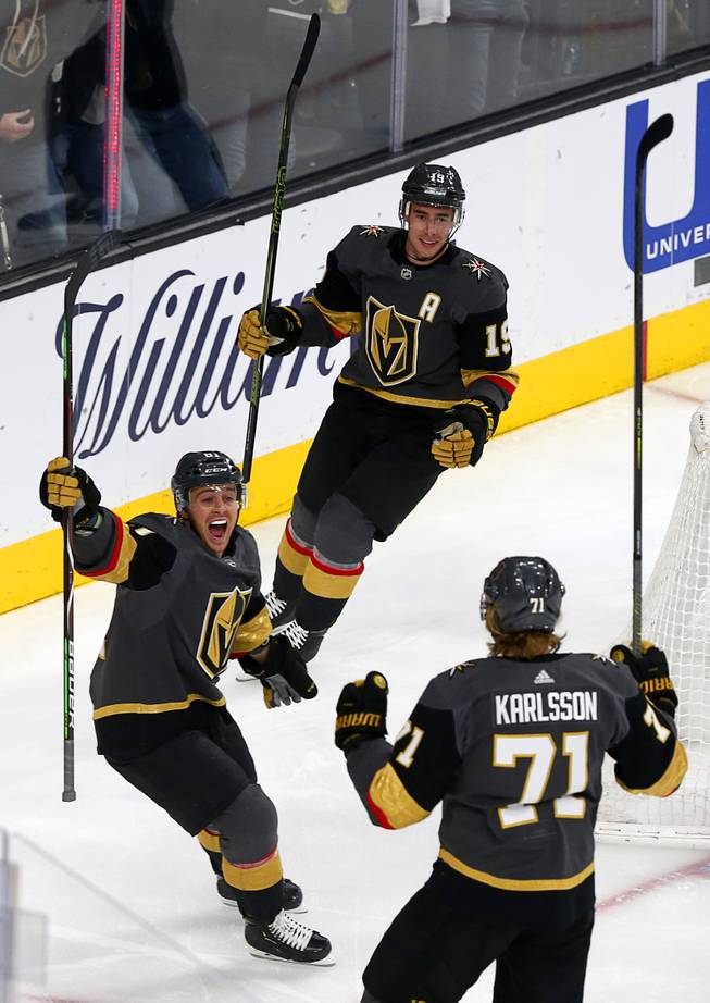 Jonathan Marchessault, left, (81), Reilly Smith, top, (19) and William Karlsson (71) celebrate a goal by Karlsson in the first period against the Winnipeg Jets at T-Mobile Arena Thursday, March 21, 2019.