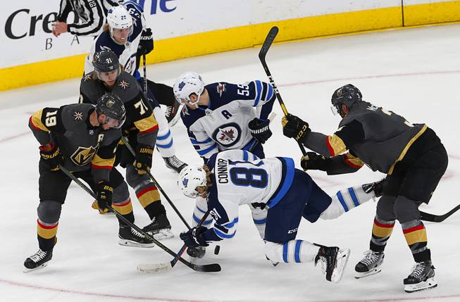 Winnipeg Jets left wing Kyle Connor (81) falls as he chases the puck during a game against the Vegas Golden Knights at T-Mobile Arena Thursday, March 21, 2019.
