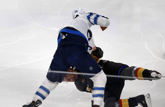 Vegas Golden Knights right wing Mark Stone, bottom, gets into a fight with Winnipeg Jets right wing Blake Wheeler (26) in the first period at T-Mobile Arena Thursday, March 21, 2019.