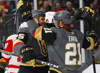 Vegas Golden Knights right wing Ryan Reaves, left, celebrates after center Cody Eakin, right, scored against the Detroit Red Wings during the second period of an NHL hockey game Saturday, March 23, 2019, in Las Vegas.