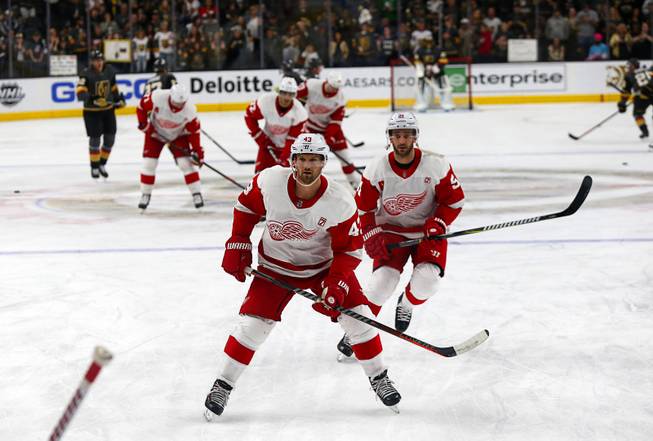 Detroit Red Wings players, including Detroit Red Wings left wing Darren Helm, center, (43) warm up before a game against the Vegas Golden Knights at T-Mobile Arena Saturday, March 23, 2019.