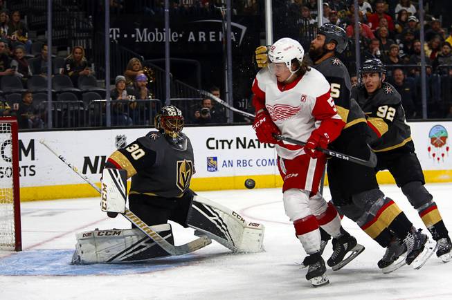 Vegas Golden Knights defenseman Deryk Engelland (5) defends against Detroit Red Wings left wing Tyler Bertuzzi (59) during the second period at T-Mobile Arena Saturday, March 23, 2019. Vegas Golden Knights goaltender Malcolm Subban (30) is at left. 