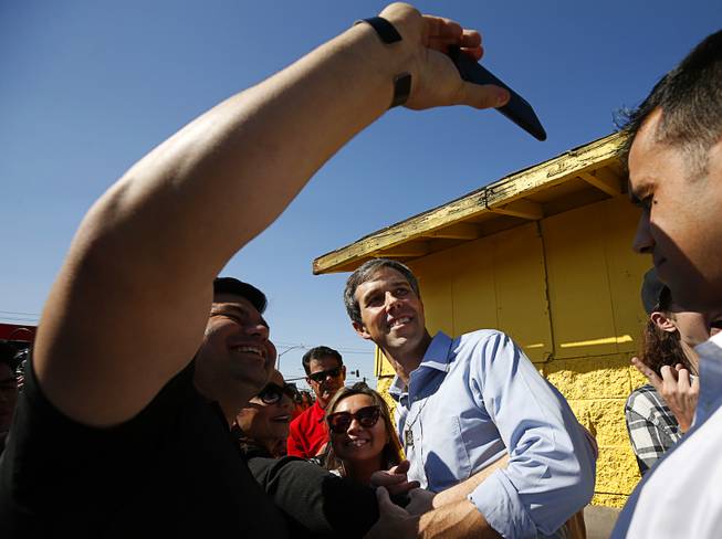 Democratic presidential candidate Beto O'Rourke of Texas poses for a selfie with a supporter during a campaign stop at Arandas Taqueria on North Nellis Boulevard Sunday, March 24, 2019.