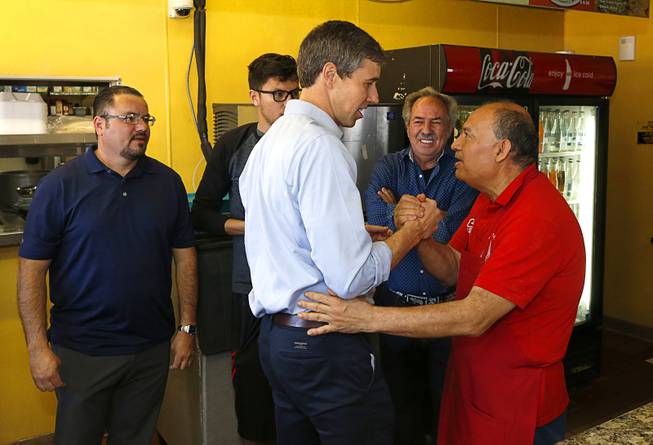 Democratic presidential candidate Beto O'Rourke of Texas talks with chef Batazar Vazquez during a campaign stop at Arandas Taqueria on North Nellis Boulevard Sunday, March 24, 2019.