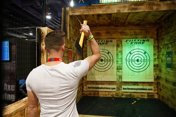 A man tries his hand at axe throwing in the Axe Throwing Builders booth during the Nightclub & Bar Convention and Trade Show at the Las Vegas Convention Center Tuesday, March 26, 2019.