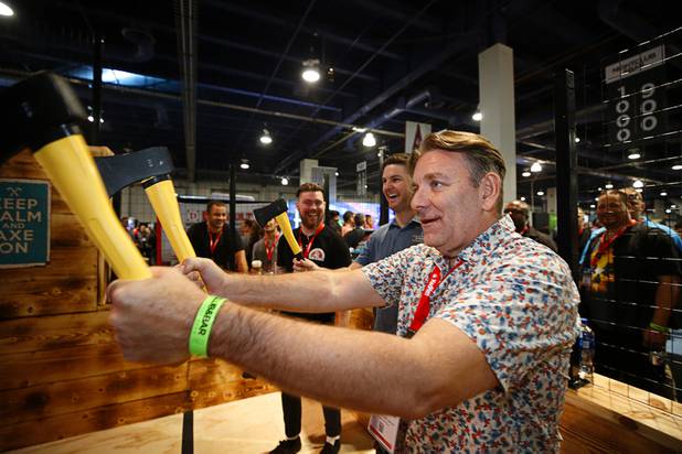 Emmanuel Sakellarakis of Australia tries his hand at axe throwing in the Axe Throwing Builders booth during the Nightclub & Bar Convention and Trade Show at the Las Vegas Convention Center Tuesday, March 26, 2019.