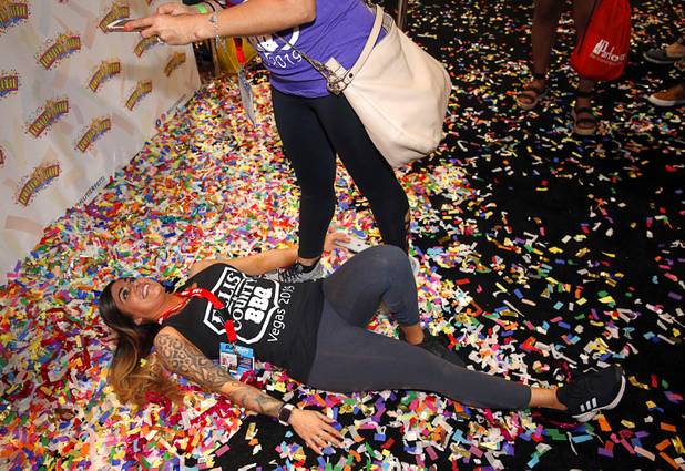 Paula Kovarik lies in Flutter Fetti during the Nightclub & Bar Convention and Trade Show at the Las Vegas Convention Center Tuesday, March 26, 2019.