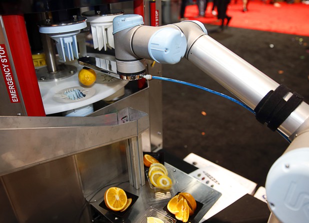 A robot arm feeds a lemon into a Sunkist Auto-90 Industrial Sectionizer during the Nightclub & Bar Convention and Trade Show at the Las Vegas Convention Center Tuesday, March 26, 2019. The machine can sectionize up to 90 pieces of fruit per minute.