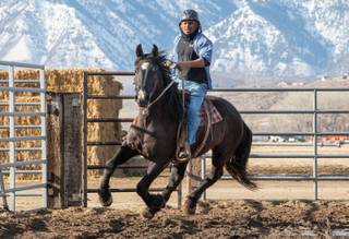 D'Juan (DJ) Thomas, an inmate at Northern Nevada Correctional Center, rides a wild horse he trained, Booger, as part of a horse training program run by the Bureau of Land Management and the Nevada Department of Corrections. Booger will be sold at an auction on March 30.