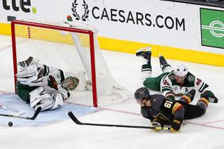 Vegas Golden Knights right wing Mark Stone's attempt at a diving wraparound goal is stopped by Minnesota Wild goaltender Devan Dubnyk (40) during the second period against the Minnesota Wild at T-Mobile Arena Friday, March 29, 2019. Minnesota Wild defenseman Ryan Suter (20) is at top right.