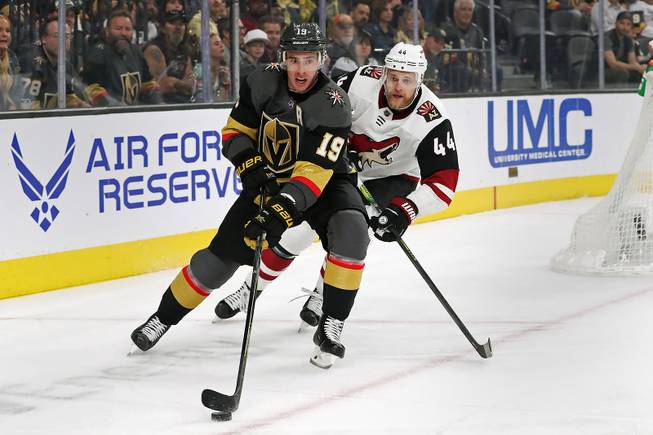Vegas Golden Knights right wing Reilly Smith (19) carries the puck with Arizona Coyotes defenseman Kevin Connauton (44) in pursuit during a game at T-Mobile Arena Thursday, April 4, 2019.