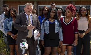 Attorney Brent Bryson, left, and Taccara Brooks, center, talk with reporters during a news conference outside the Brent Bryson law office Friday, April 5, 2019. Brooks filed a lawsuit against the Metro Police Department in connection with the death of her 16-year-old son Anthony Garrett in 2017.
