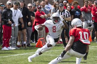 Running back Charles Williams (8) looks for an opening against Vic Viramontes (10) during the UNLV football team's Spring Showcase at the Peter Johann Memorial Field at UNLV on Saturday, April 6, 2019. Richard Brian