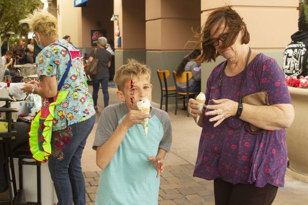 Wesley Agan 9, center, takes a bite of his ice cream while his grandma Mary Agan, right, bears the wind during Ben & Jerry's Free Cone day at The District at Green Valley Ranch Tuesday, April 9, 2019. All donations benefit the Court Appointed Special Advocate (CASA) Foundationa nonprofit group supporting children in foster care.
