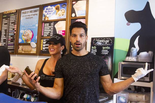 Celebrity scoopers Jennifer Romas from Sexxy, left, and BMXer Ricardo Laguna, right, pose for a photo during Ben & Jerry's Free Cone day at The District at Green Valley Ranch Tuesday, April 9, 2019. All donations benefit the Court Appointed Special Advocate (CASA) Foundationa nonprofit group supporting children in foster care.