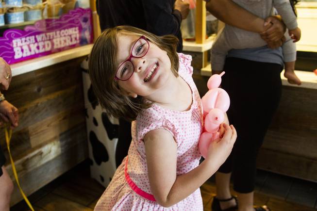 Margo McGuinness, 6, with her balloon animal reacts to the camera as she makes her way to the front of the line during Ben & Jerry's Free Cone day at The District at Green Valley Ranch Tuesday, April 9, 2019. All donations benefit the Court Appointed Special Advocate (CASA) Foundationa nonprofit group supporting children in foster care.