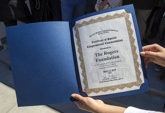 Cassandra Munoz, representing Congresswoman Dina Titus, D-Nev., displays a certificate ...
