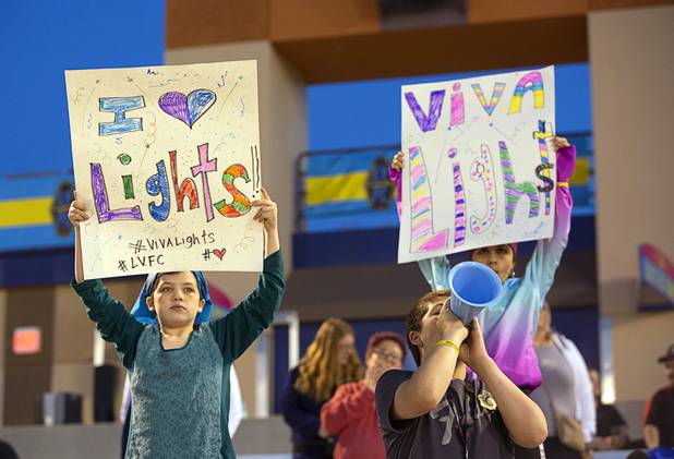 Las Vegas Lights FC fans Madison, left, 11, Makayla, 13, and Mike Carney, 14, show their support for the team during a game against the Tacoma Defiance at Cashman Field Saturday, April 13, 2019. The Lights shut out the Defiance 5-0.