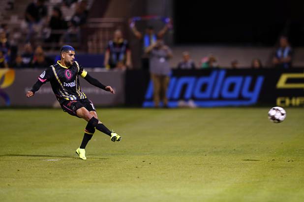 Las Vegas Lights' Irvin Parra (11) scores on a penalty kick during a game against the  Tacoma Defiance at Cashman Field Saturday, April 13, 2019. The Lights shut out the Defiance 5-0.
