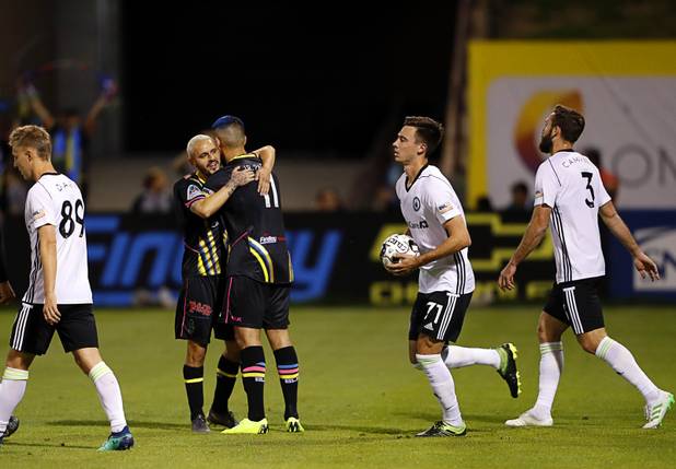 Las Vegas Lights' Pablo Cruz, left, (7) congratulates Irvin Parra (11) after a gaol against the Tacoma Defiance at Cashman Field Saturday, April 13, 2019. The Lights shut out the Defiance 5-0.