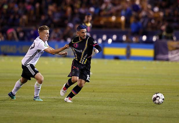 Tacoma Defiance's Jesse Daley (89) holds back Las Vegas Lights' Lucas Scaglia (16) during a game at Cashman Field Saturday, April 13, 2019. The Lights shut out the Defiance 5-0.