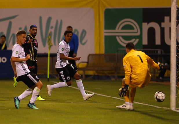Las Vegas Lights' Irvin Parra (11) scores past Tacoma Defiance goaltender Trey Muse (1) during a game against the  Tacoma Defiance at Cashman Field Saturday, April 13, 2019. The Lights shut out the Defiance 5-0.