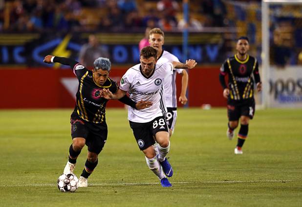 Las Vegas Lights' Kevin Garcia Lopez (3) fends off Tacoma Defiance's Matt Nance at Cashman Field Saturday, April 13, 2019. The Lights shut out the Defiance 5-0.